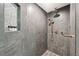 Large walk-in shower with gray tile and gold fixtures at 1990 Main St # 6, Sarasota, FL 34236