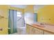 Clean bathroom with a tub shower, vanity with sink and yellow walls at 2044 Canal Dr # M37, Bradenton, FL 34207