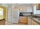 Modern kitchen with white appliances and light wood cabinets at 2044 Canal Dr # M37, Bradenton, FL 34207