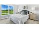 Well-lit bedroom featuring a plush bed and plenty of natural light at 21192 Winside Ave, Port Charlotte, FL 33952