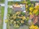 An aerial view showcasing a house with a pool, shed, and surrounding landscape at 21264 Wynyard Ave, Port Charlotte, FL 33954