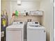 Functional laundry room with washer, dryer, and storage at 21264 Wynyard Ave, Port Charlotte, FL 33954