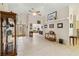 Living room with tile floors, wood display cabinet, and access to other rooms at 21264 Wynyard Ave, Port Charlotte, FL 33954