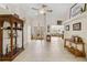 Living room with tile floors, wood display cabinet, and access to other rooms at 21264 Wynyard Ave, Port Charlotte, FL 33954