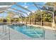 Inviting screened-in pool with spa and lush landscaping at 21264 Wynyard Ave, Port Charlotte, FL 33954