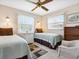 Bedroom with two twin beds and ceiling fan at 2153 Pueblo Cir # V14, Sarasota, FL 34231