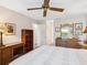 Spacious bedroom with wicker furniture and ceiling fan at 2153 Pueblo Cir # V14, Sarasota, FL 34231