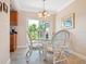 Charming dining area with a glass-top table and wicker chairs at 2153 Pueblo Cir # V14, Sarasota, FL 34231