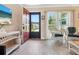 Living room entryway with a red door and white wicker chairs at 2153 Pueblo Cir # V14, Sarasota, FL 34231