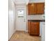 White door and wood cabinets in kitchen area at 2153 Pueblo Cir # V14, Sarasota, FL 34231