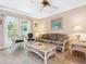 Living room with white wicker furniture and a ceiling fan at 2153 Pueblo Cir # V14, Sarasota, FL 34231