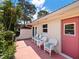 Private patio with seating and a pink door at 2153 Pueblo Cir # V14, Sarasota, FL 34231