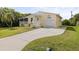 Yellow house with a carport, porch, and nicely landscaped lawn at 2711 Larkspur Dr, Punta Gorda, FL 33950