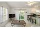 Bright living room with a view of the kitchen and screened porch at 2711 Larkspur Dr, Punta Gorda, FL 33950