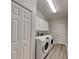 Laundry room with washer, dryer, cabinets, and vinyl flooring at 2914 112Th E Ter, Parrish, FL 34219