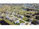 Community aerial view of the golf course homes, surrounding water, and landscape at 31 Bunker Pl, Rotonda West, FL 33947