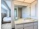 Bright bathroom featuring a vanity with a sink and a mirror, plus a view into the bedroom at 31 Bunker Pl, Rotonda West, FL 33947