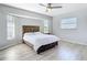 A serene bedroom featuring hardwood floors, natural light and a rustic wood-framed bed at 31 Bunker Pl, Rotonda West, FL 33947