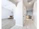 Hallway leading to dining room and kitchen featuring tile flooring, freshly painted walls, and natural light at 31 Bunker Pl, Rotonda West, FL 33947