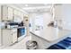 A well-lit kitchen with white appliances and cabinets, complemented by tile flooring and a skylight at 31 Bunker Pl, Rotonda West, FL 33947