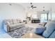 Open concept living room featuring plush sofas, a ceiling fan, tiled flooring and easy access to the kitchen and patio at 31 Bunker Pl, Rotonda West, FL 33947