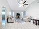 Bright living room featuring a skylight, ceiling fan, and neutral-toned couches on a decorative starfish rug at 31 Bunker Pl, Rotonda West, FL 33947