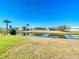 Picturesque waterfront view of canal, lawn and neighboring homes at 31 Bunker Pl, Rotonda West, FL 33947