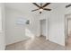 Bedroom with ceiling fan, closet, and access to hallway at 3107 34Th Avenue W Dr, Bradenton, FL 34205