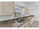 Modern kitchen with granite countertops and stainless steel sink at 3107 34Th Avenue W Dr, Bradenton, FL 34205