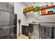 Functional laundry room with washer, dryer, and extra shelving at 3218 Big Sky Way, Bradenton, FL 34211