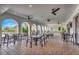 Outdoor kitchen and patio area with seating and ceiling fans at 3218 Big Sky Way, Bradenton, FL 34211