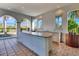 Outdoor kitchen with granite countertops and white cabinets at 3218 Big Sky Way, Bradenton, FL 34211