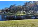 Serene lakefront view with gazebo and lush landscaping at 3230 Banyan Ter, Sarasota, FL 34237