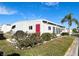 House exterior view, showcasing landscaping and red door at 3230 Banyan Ter, Sarasota, FL 34237