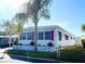 Side view of manufactured home showcasing landscaping at 3230 Banyan Ter, Sarasota, FL 34237