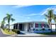 Well-maintained manufactured home with carport and landscaping at 3230 Banyan Ter, Sarasota, FL 34237