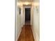 Light and bright hallway with wood-look flooring and neutral walls at 3230 Banyan Ter, Sarasota, FL 34237