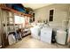 Laundry room includes washer, dryer, and extra storage at 3230 Banyan Ter, Sarasota, FL 34237