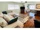 Spacious living room featuring a large sectional sofa and wood-look flooring at 3230 Banyan Ter, Sarasota, FL 34237