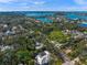 Aerial view of a home with a pool, surrounded by lush greenery near the water at 3331 Old Oak Dr, Sarasota, FL 34239