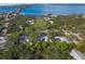 An aerial view of a home near the water, surrounded by trees and other houses at 3331 Old Oak Dr, Sarasota, FL 34239