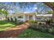 Charming white home with brick walkway and well-manicured lawn at 3331 Old Oak Dr, Sarasota, FL 34239