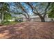 White house with brick driveway and mature oak trees at 3331 Old Oak Dr, Sarasota, FL 34239