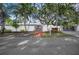 Front view of a white house with a gated entrance and brick walkway at 3331 Old Oak Dr, Sarasota, FL 34239