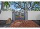 Elegant home entrance with gray metal gates and brick pathway at 3331 Old Oak Dr, Sarasota, FL 34239