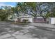 Modern house exterior with gray gates and lush landscaping at 3331 Old Oak Dr, Sarasota, FL 34239