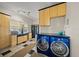 Laundry room with stylish blue washer and dryer, and built-in cabinetry at 3331 Old Oak Dr, Sarasota, FL 34239