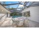 Relaxing pool and patio area with screened enclosure and outdoor kitchen at 3331 Old Oak Dr, Sarasota, FL 34239