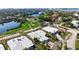 Aerial view of a luxurious home with golf course and water views at 3491 Byron Ln, Longboat Key, FL 34228