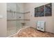 Large bathroom with glass shower and marble floors at 3491 Byron Ln, Longboat Key, FL 34228